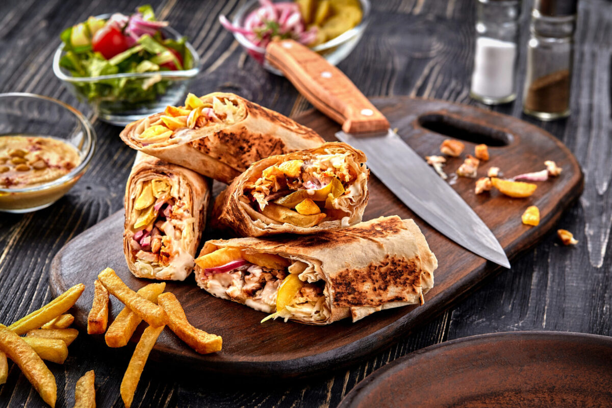 Iky Shawarma chicken roll in a pita with fresh vegetables, cream sauce and french fries lebanese cuisine.shawarma.middle eastern cuisine.street food